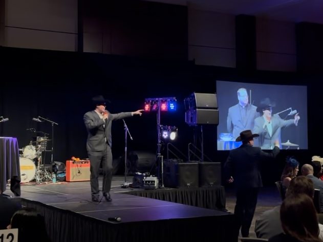 Alex Ackel calling a live auction from the stage