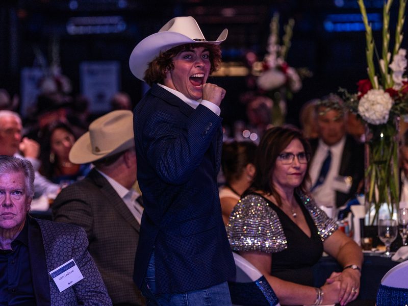 Alex Ackel calling out a bid from the floor at a gala